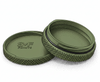 Two green plastic containers with textured lids on a white background